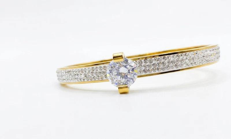 Gold ring with a diamond on a white background