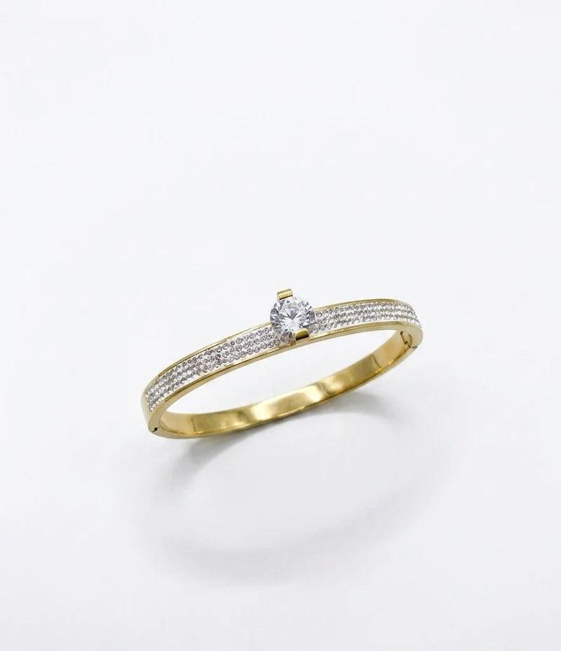 Gold ring with a diamond on a white background
