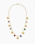 A gold chain necklace featuring multiple small shell-shaped charms and round bezel-set colorful stones in purple, pink, green, red, blue, and dark blue, displayed on a clean white background.