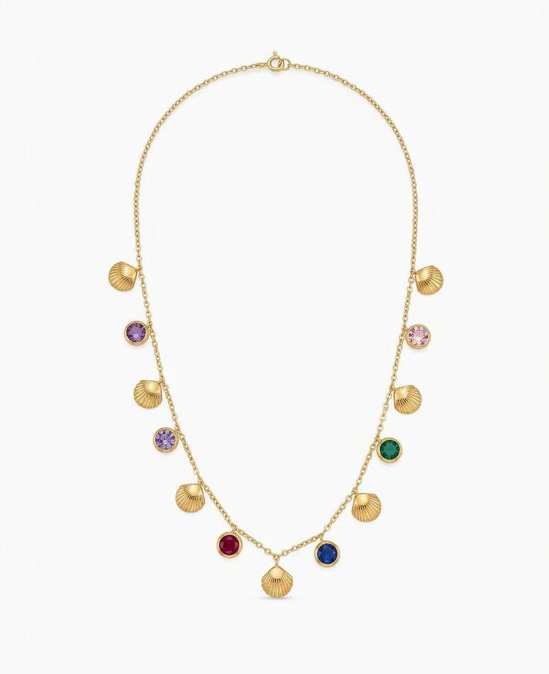 A gold chain necklace featuring multiple small shell-shaped charms and round bezel-set colorful stones in purple, pink, green, red, blue, and dark blue, displayed on a clean white background.