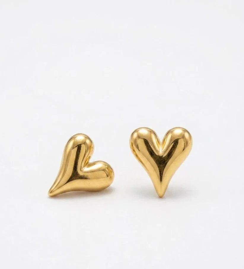 Gold heart-shaped earrings on a white background