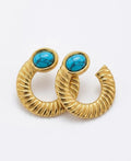 Gold hoop earrings with turquoise stones on a white background