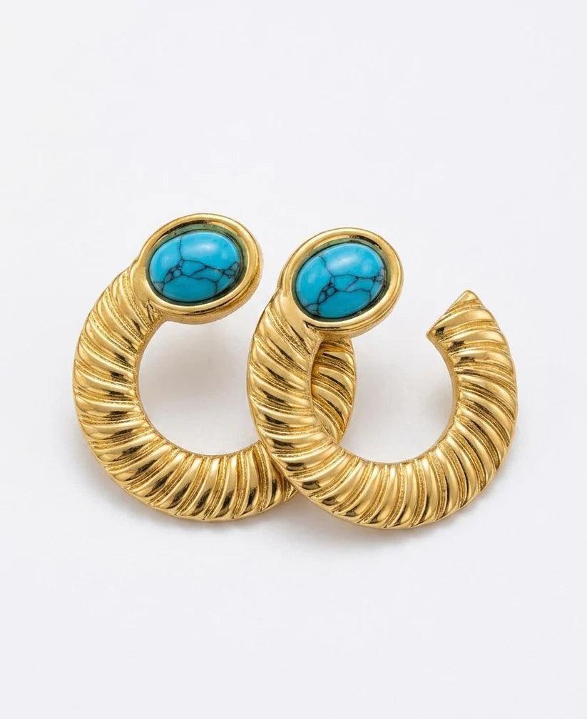 Gold hoop earrings with turquoise stones on a white background