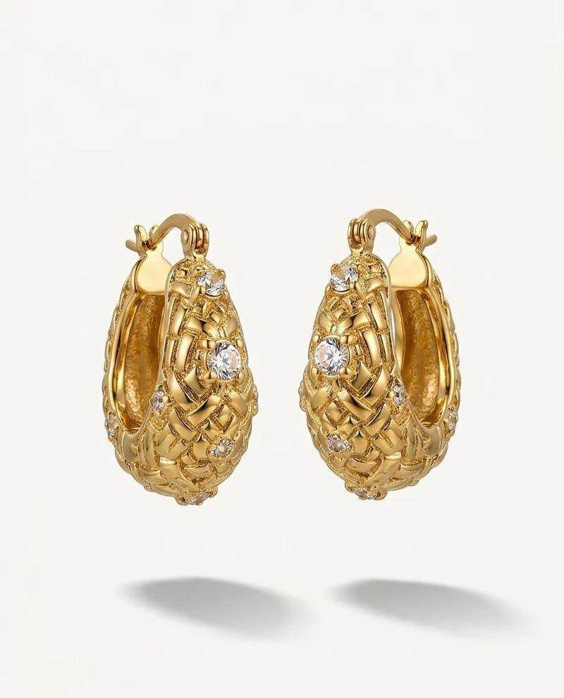 Gold hoop earrings with diamond accents on a white background