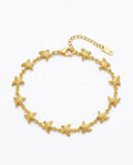 A gold starfish chain bracelet with a lobster clasp and extension chain, displayed on a clean white background.