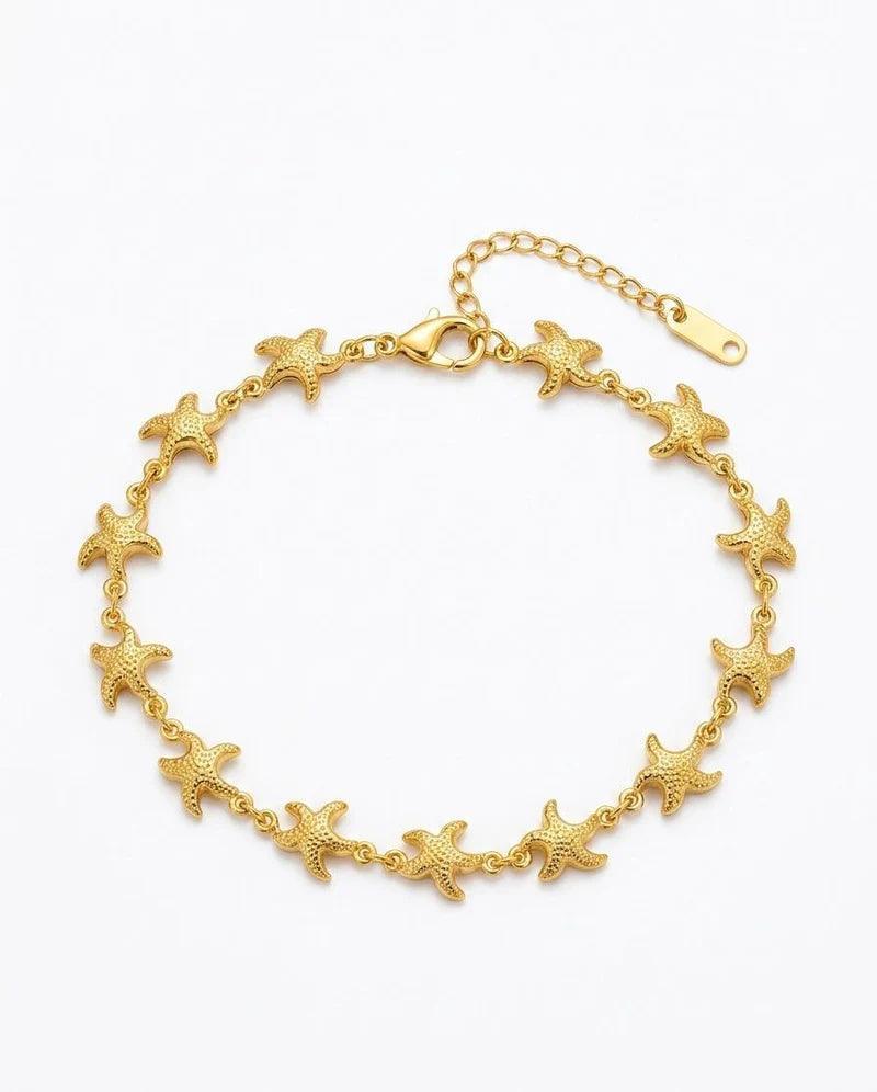 A gold starfish chain bracelet with a lobster clasp and extension chain, displayed on a clean white background.