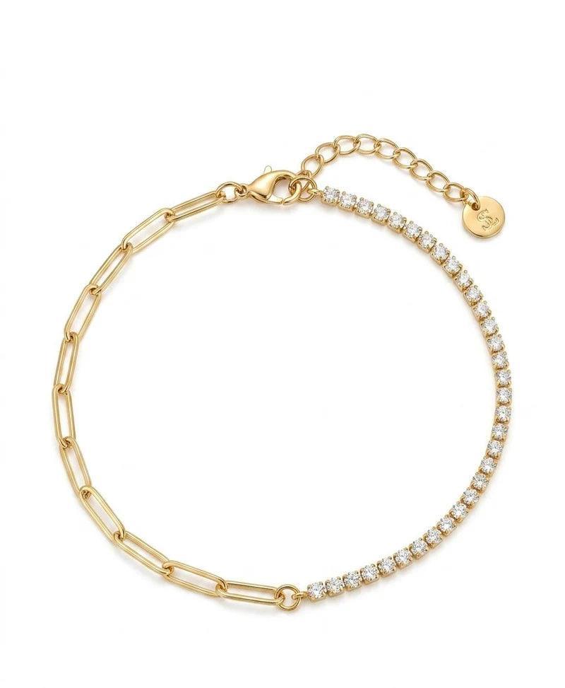 Gold bracelet with clear stones on a white background