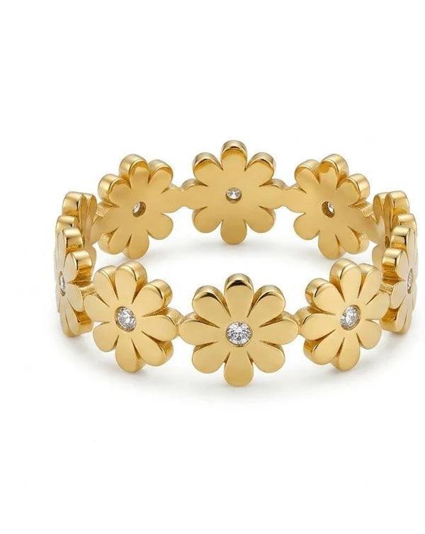Gold bracelet with floral designs on a white background
