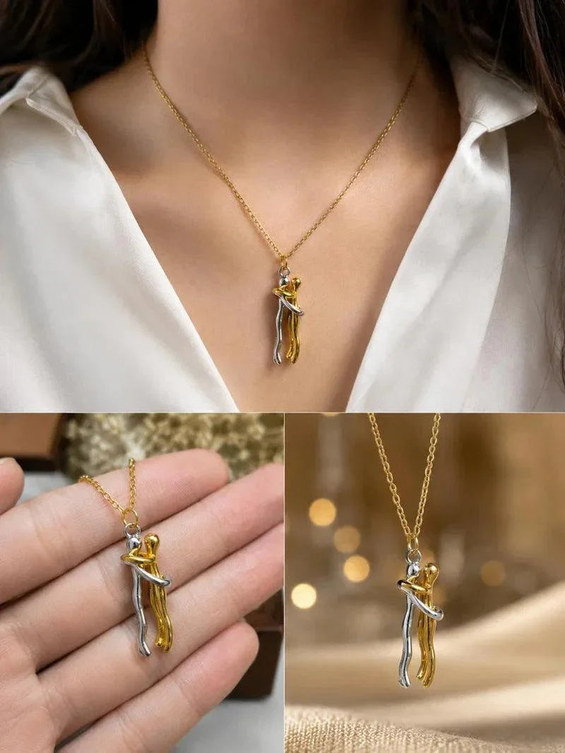 A collage showing a gold and silver pendant necklace worn on a model's neck, held in a hand, and photographed close-up against a warm blurred background. The pendant depicts two small figures embracing.