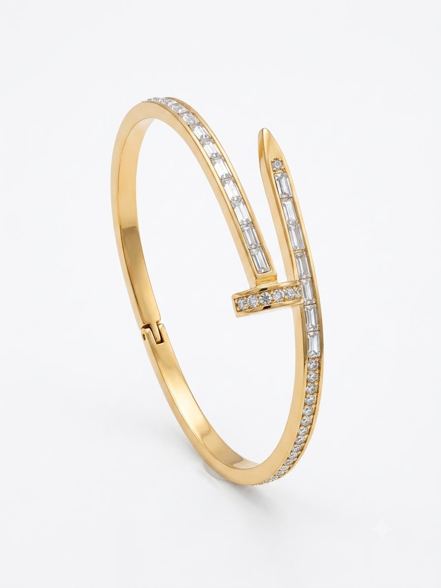 A gold hinged bangle bracelet featuring a stylized 'V' design paved with small clear baguette and round-cut stones, shown on a clean white background.