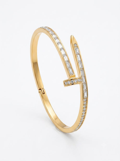 A gold hinged bangle bracelet featuring a stylized 'V' design paved with small clear baguette and round-cut stones, shown on a clean white background.