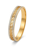 A gold band ring featuring a Greek key pattern with rows of small clear stones, shown on a clean white background.