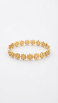 A gold flower bangle bracelet with small white gemstone centers, displayed on a clean white background.