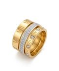 Gold ring with Roman numeral design and embedded diamonds on a white background
