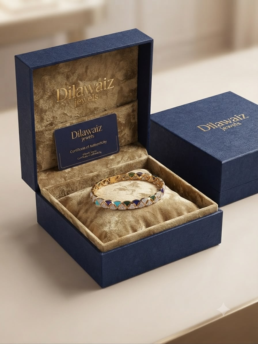 A gold-plated bangle bracelet with colorful enamel accents, presented inside an open navy blue Dilawaiz Jewels box on a beige surface.