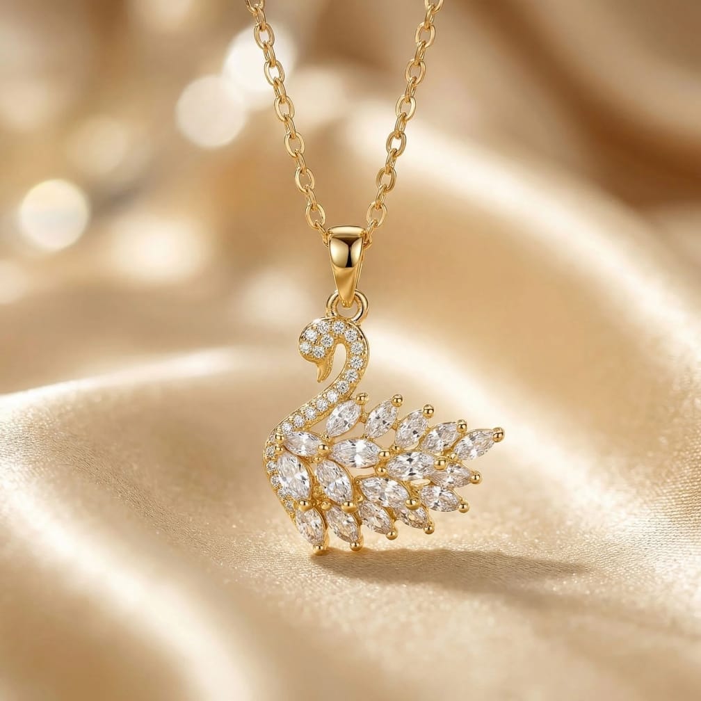 Gold swan-shaped necklace with diamond accents on a gold background